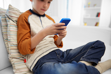 Image showing close up of boy with smartphone at home