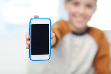 Image showing close up of boy with smartphone at home