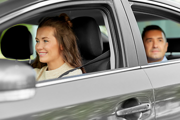 Image showing female driver driving car with male passenger