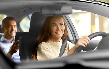 Image showing female driver driving car with male passenger