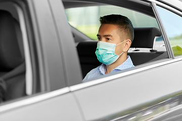 Image showing man or male passenger wearing mask in car