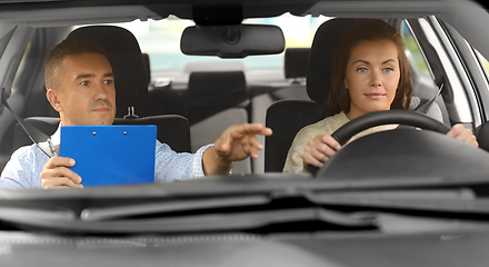 Image showing car driving school instructor and young driver