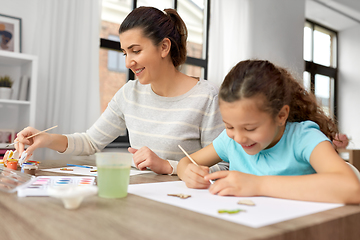 Image showing happy mother with little daughter drawing at home