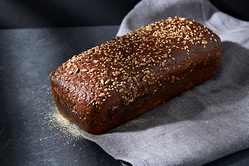 Image showing homemade craft bread with seeds on table