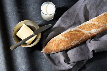 Image showing close up of bread, butter, knife and glass of milk