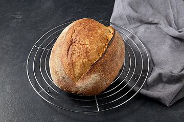 Image showing homemade craft bread on stand on table