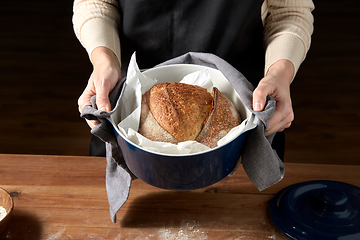 Image showing female baker with homemade bread at bakery