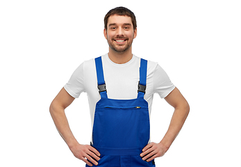 Image showing happy smiling male worker or builder in overall