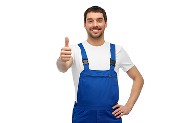 Image showing happy male worker or builder showing thumbs up