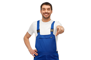 Image showing happy male worker or builder pointing to camera