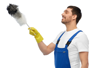 Image showing happy male worker or cleaner with duster cleaning