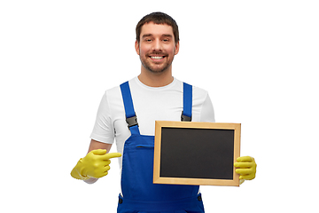 Image showing smiling worker or male cleaner showing chalkboard