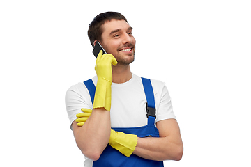 Image showing happy male worker or cleaner calling on smartphone