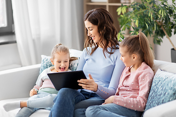 Image showing happy mother and daughters with tablet pc at home