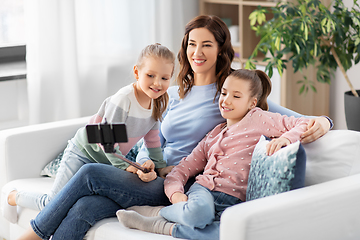 Image showing happy family taking selfie by smartphone at home