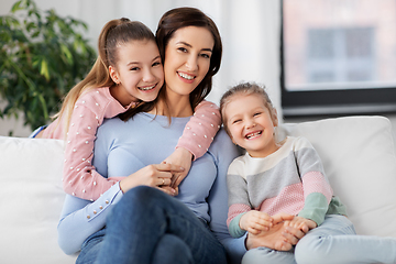 Image showing happy smiling mother with two daughters at home