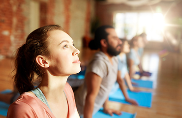 Image showing group of people doing yoga cobra pose at studio