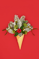 Image showing Christmas Ice Cream Cone Surreal Concept with Winter Greenery 