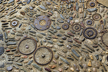 Image showing Unusual floor with pattern from pebbles and metal details