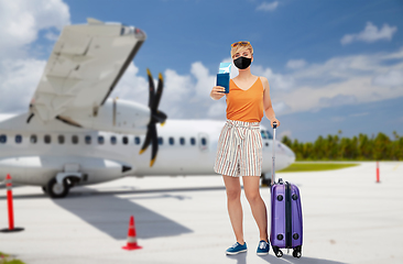 Image showing woman in mask with bag and ticket over plain