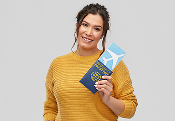 Image showing happy woman with air ticket and immunity passport