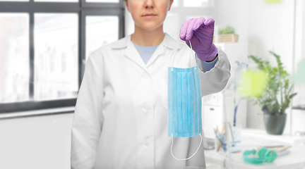 Image showing female doctor in gloves showing medical mask