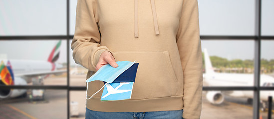 Image showing woman with mask, passport and ticket at airport