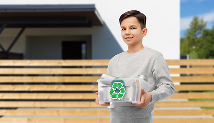 Image showing smiling boy sorting metallic waste over house