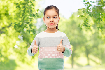 Image showing happy smiling girl showing thumbs up