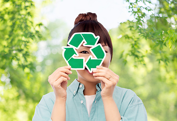 Image showing smiling asian woman holding green recycling sign