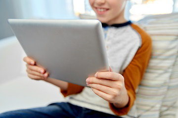 Image showing close up of boy with tablet pc computer at home