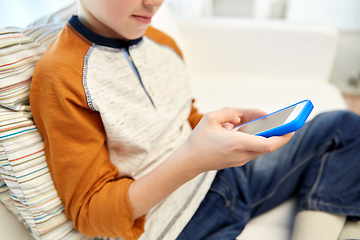 Image showing close up of boy with smartphone at home