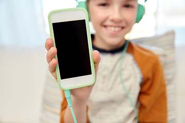 Image showing boy with headphones and smartphone at home