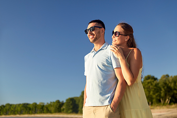 Image showing happy couple hugging on summer beach