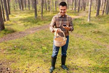 Image showing man using smartphone to identify mushroom