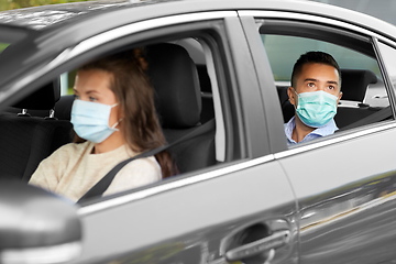 Image showing female driver in mask driving car with passenger