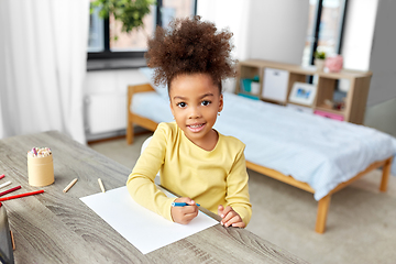 Image showing little girl drawing with coloring pencils at home