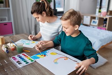 Image showing mother and son with colors drawing at home