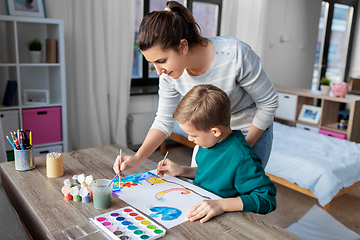 Image showing mother and son with colors drawing at home