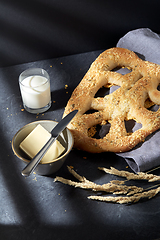 Image showing close up of cheese bread, butter, knife and milk