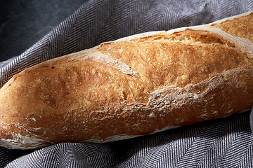 Image showing close up of baguette bread on kitchen towel