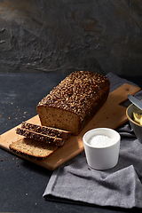 Image showing close up of bread, butter, knife and salt on towel