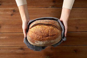 Image showing female baker with homemade bread at bakery