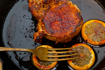 Image showing pork chop seared on iron skillet