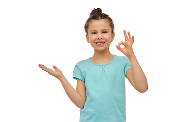 Image showing happy smiling girl holding something imaginary