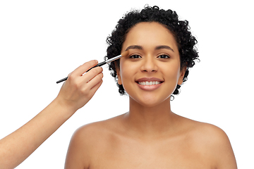 Image showing happy woman and hand of make up artist with brush