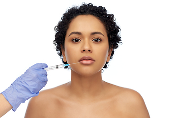 Image showing face of african woman and hand with syringe