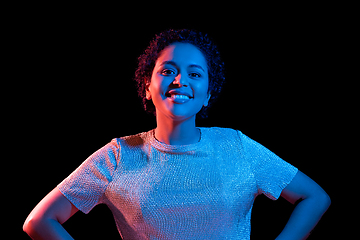 Image showing african woman over neon lights on black background