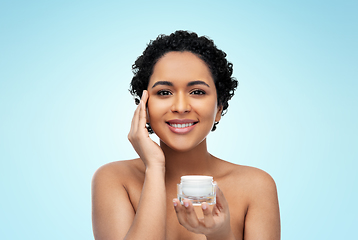 Image showing young african american woman with moisturizer