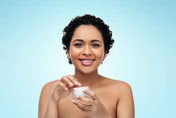 Image showing young african american woman with moisturizer